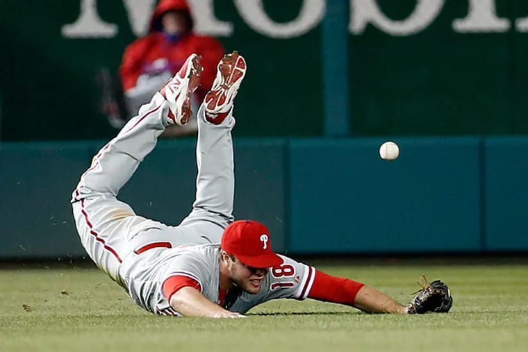 Philadelphia Phillies left fielder Darin Ruf (18) can't catch an RBI single hit by Washington Nationals' Wilson Ramos during the fourth inning of a baseball game at Nationals Park, Thursday, April 16, 2015, in Washington. (AP Photo/Alex Brandon)