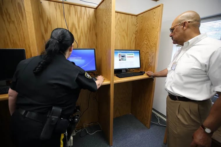 William E. Hart, director of employer management for the Philadelphia Department of Prisons, and a prison guard fire up computers in a trailer outside the Curran Fromhold Correctional Facility in Philadelphia.