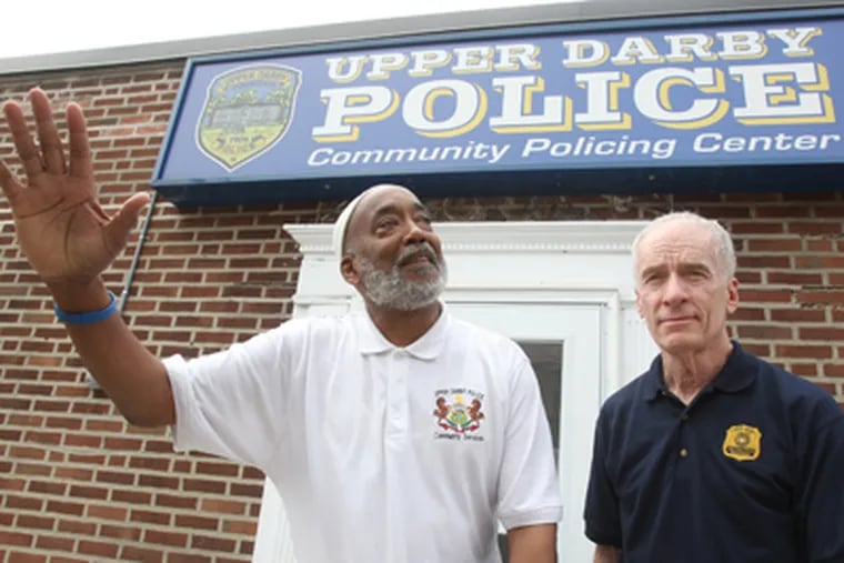 In Upper Darby, which has seen crime rise, Nashid Furaha-Ali (left), civilian liaison officer, and Michael Chitwood, police superintendent, outside a community police station. (Charles Fox / Staff Photographer)