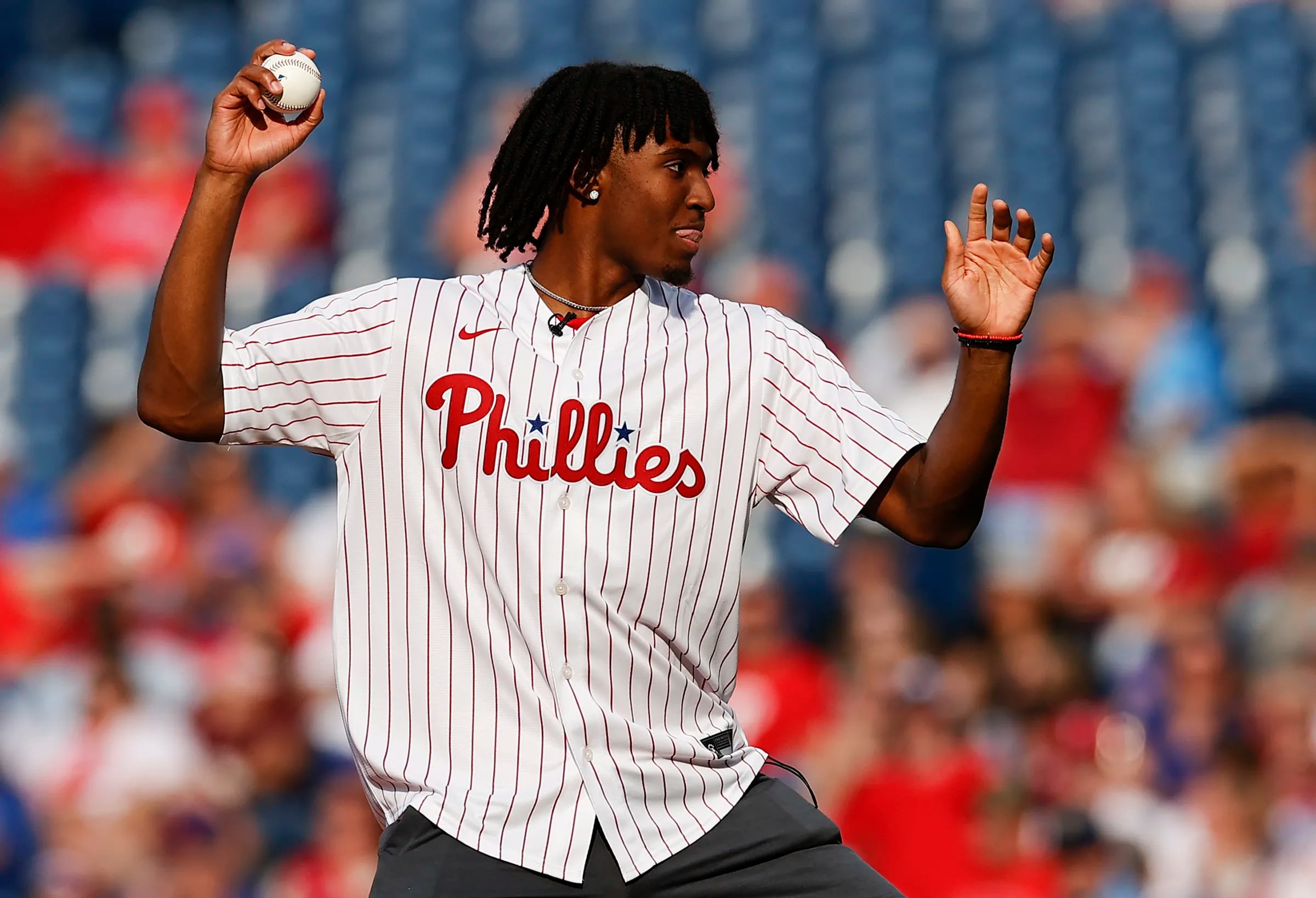 Sixers guard Tyrese Maxey throws the ceremonial first pitch.