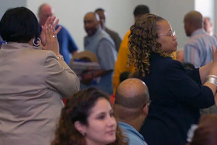 Audience members respond to remarks at yesterday&#0039;s boisterous School Reform Commission meeting.