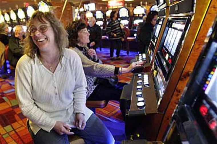 Diane Oberlander of Levittown plays a penny slot machine at PhiladelphiaPark Casino in Bensalem. ( Elizabeth Robertson / Staff Photographer )