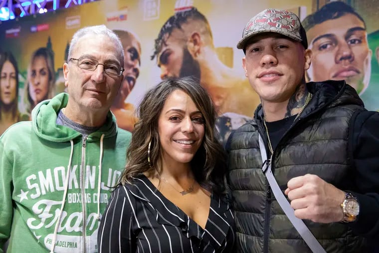 Michelle Rosado, center, poses for a portrait with boxer Gabriel Rosado, right, and her mentor, Russell Peltz, during a press conference.