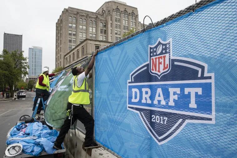 Workers make preparations ahead of the 2017 NFL football draft, in Philadelphia, Wednesday, April 26, 2017.