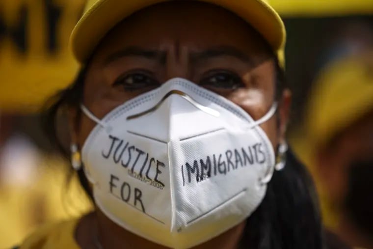 An immigration activist participates in a rally near the White House on Oct. 7, 2021, in Washington, D.C. The group demonstrated for immigration reform and urged President Joe Biden to authorize a pathway to citizenship for undocumented immigrants.