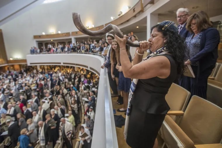 Sara Partiyeli Bloom blows the shofar from the balcony at Old York Road Temple-Beth Am during Thursday’s Rosh Hashanah service.