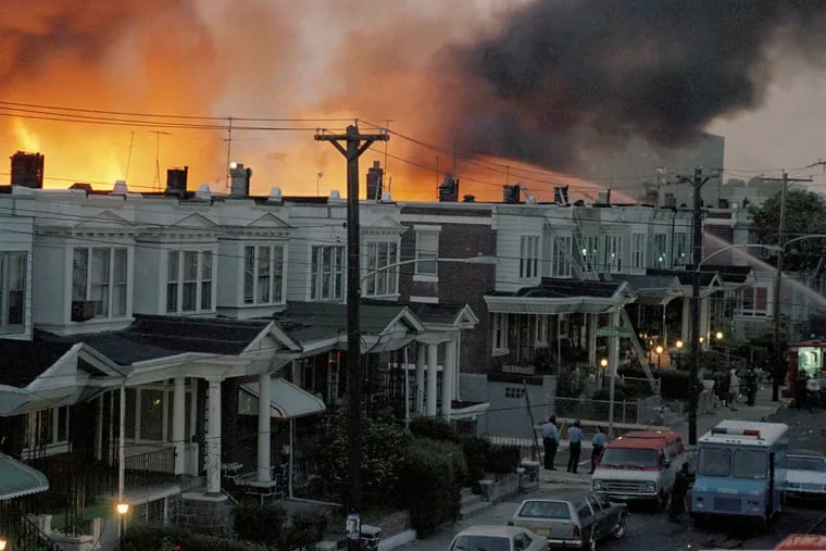 Scores of rowhouses burn in a fire in the West Philadelphia neighborhood where police dropped a bomb on MOVE's home on May 13, 1985.