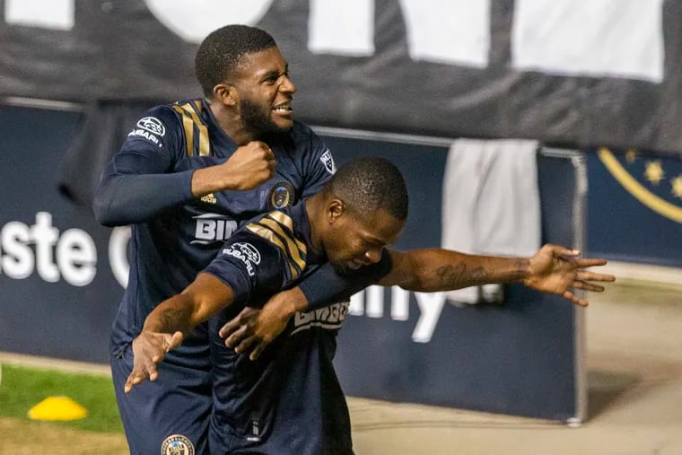 Mark McKenzie, top, leaps upon Cory Burke of the Philadelphia Union after he scored the winning goal against the Chicago Fire during the second half on Oct. 28, 2020  at Subaru Stadium in Chester, PA