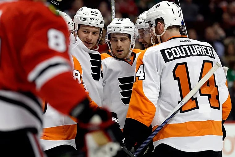 Philadelphia Flyers defenseman Andrew MacDonald (47), second from
right, celebrates with teammates after scoring his goal against the
Chicago Blackhawks during the first period of an NHL hockey game
Wednesday, March 16, 2016, in Chicago.