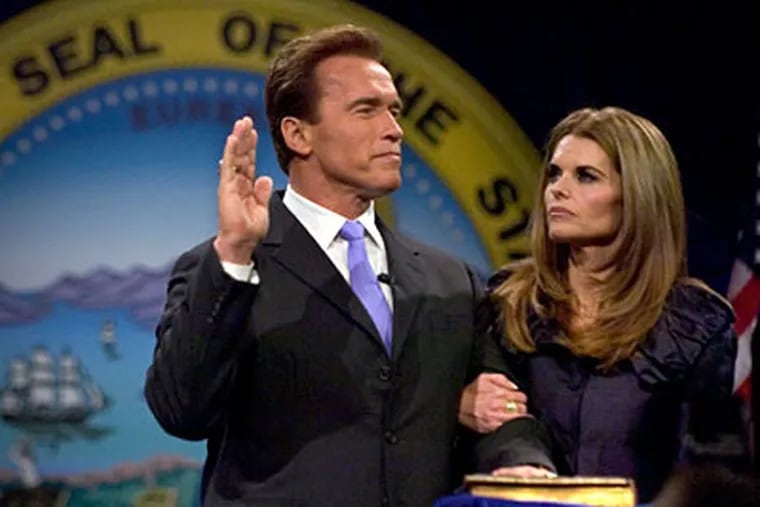 In happier times, Maria Shriver holds onto her husband, Arnold Schwarzenegger, during his swearing-in ceremony as governor of California at Memorial Auditorium in Sacramento, California, on January 5, 2007. (Renee C. Byer/Sacramento Bee/MCT)