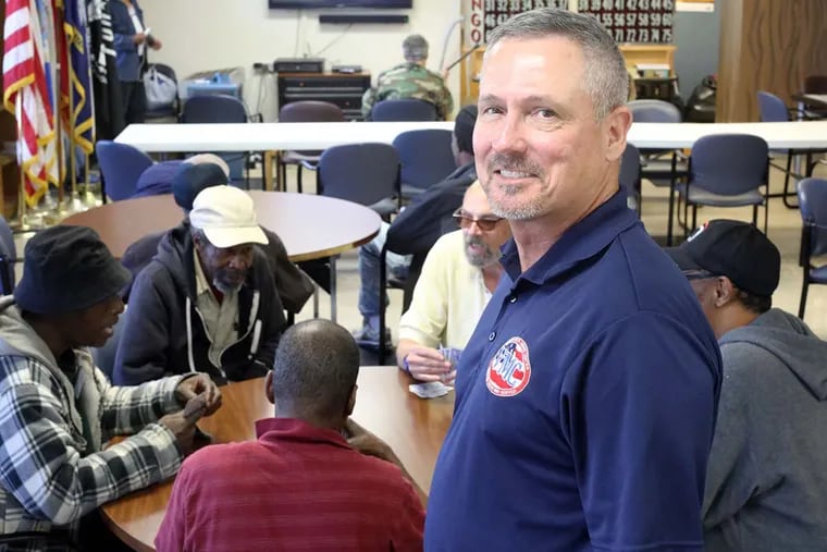 Tim Williams oversees veterans playing cards at the Veterans Multi-Service Center on North Fourth Street. He can relate: For him, the transition to civilian life was particularly rough.