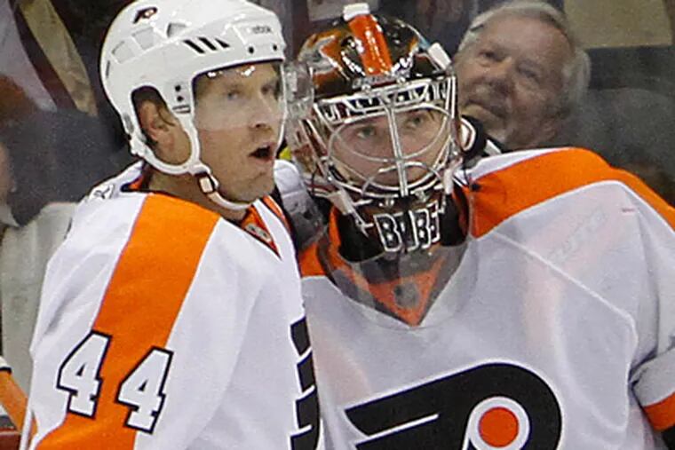 Sergei Bobrovsky celebrates with Kimmo Timonen after the Flyers beat the Penguins 3-2 in their season opener. (AP Photo/Keith Srakocic)