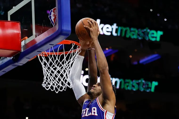 Sixers forward Tobias Harris attempts to dunk the basketball while getting fouled by Atlanta Hawks center Clint Capela in the second quarter on Oct. 30.
