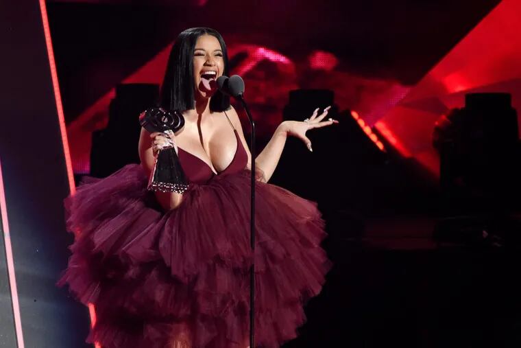 FILE – In this March 11, 2018, file photo, Singer Cardi B accepts the Best New Artist award during the 2018 iHeartRadio Music Awards at The Forum in Inglewood, Calif. Cardi B has revealed during a &quot;Saturday Night Live&quot; performance she's pregnant. Cardi B's debut album was released Friday, April 6. &quot;Invasion of Privacy&quot; is set for a No. 1 Billboard debut. (Photo by Chris Pizzello/Invision/AP, File)
