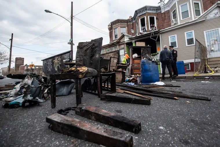 Investigators work Sunday to determine the cause of a fire that killed a Philadelphia grandmother and two of her grandchildren Saturday in the 4200 block of North Reese Street.