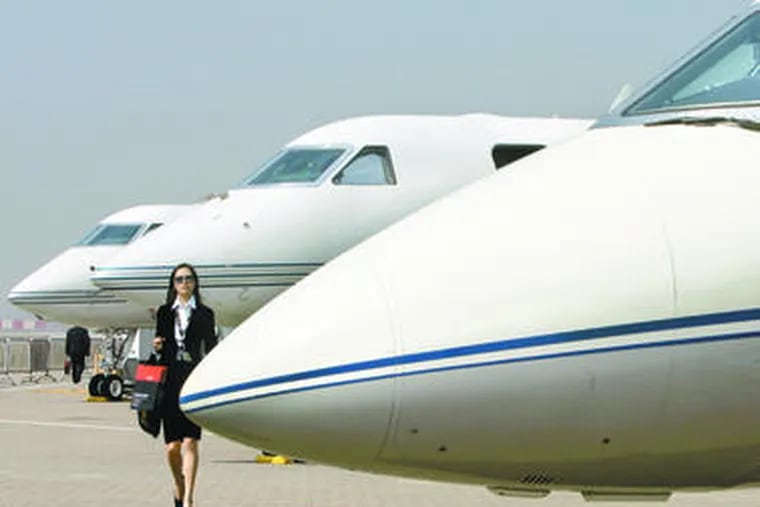 A visitor looks over Gulfstream business jets at a 2007 exhibition in Hong Kong. Benefits paid out to executives at banks receiving bailout funds included personal use of company jets.