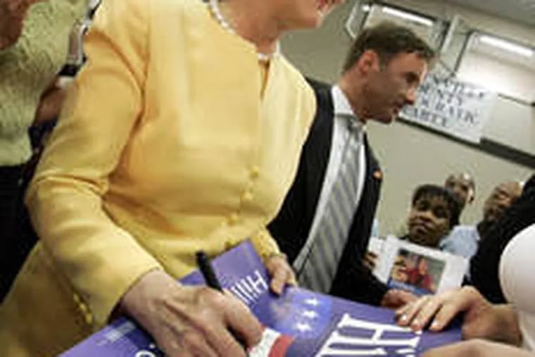 Sen. Hillary Rodham Clinton of New York signs a poster as she greets supporters after speaking in Greenville, S.C.