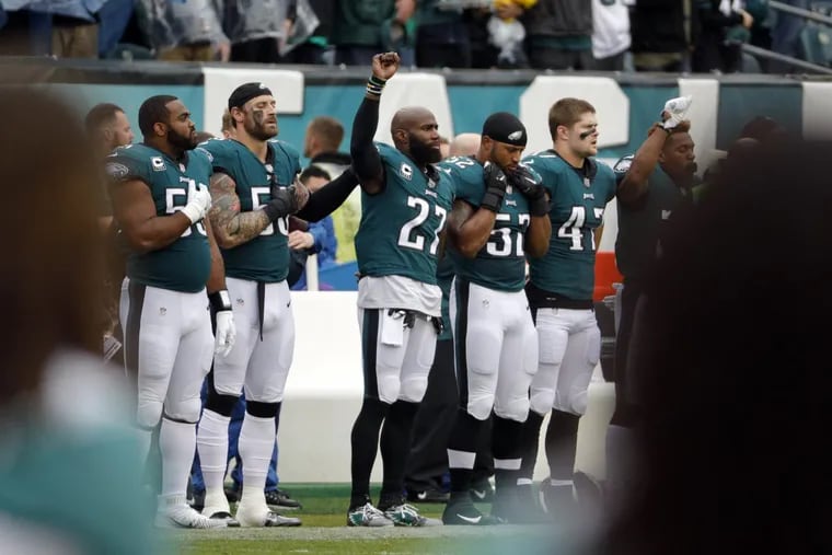 The Eagles’ Malcolm Jenkins (27) raises his fist during the playing of the national anthem on Sunday.