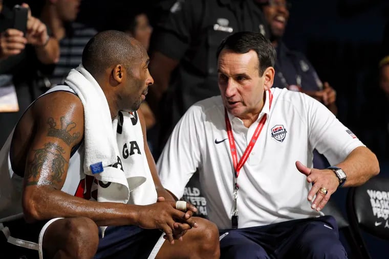 Kobe Bryant (left) talks with head coach Mike Krzyzewski in 2012 during a USA Basketball practice before that year's Olympics.