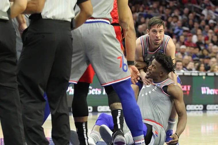 TJ McConnell, top right ,of the Sixers drags teammate Jimmy Butler away from a potential altercation after a flagrant foul by Alex Len of the Hawks in the 2nd half on Jan. 11, 2019.  