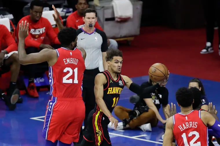 Sixers center Joel Embiid defends Atlanta Hawks guard Trae Young during the first quarter in Game 1 of the NBA Eastern Conference playoff semifinals on Sunday, June 6, 2021.