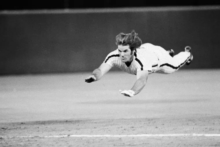 Pete Rose's takes his signature headfirst slide into third base during a 1981 game with the Phillies.