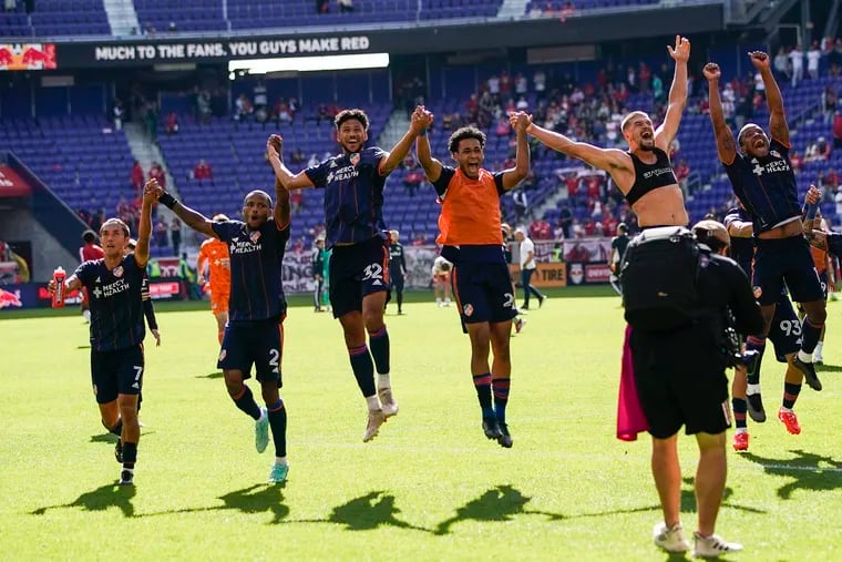 FC Cincinnati players including former Union players Sergio Santos (right) and Alvas Powell (second from left) celebrate after their 2-1 win over the New York Red Bulls in the first round of the playoffs.