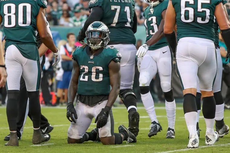 Philadelphia Eagle running back Jay Ajayi, center, can only kneel on the ground and look to the sky after he fumbled the ball inside the 10 yard line as the Eagles were looking to score in the third quarter. The Vikings recovered and marched down the field and scored a touchdown during the Game in Sunday October 7, 2018. MICHAEL BRYANT / Staff Photographer