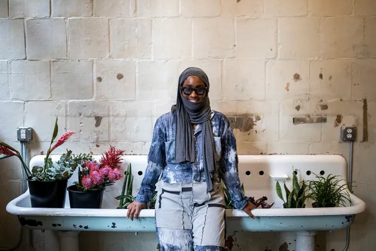Domino Mack, 31, of West Philadelphia, owner of DNA Floral, poses for a portrait inside her new space at the Bok building.