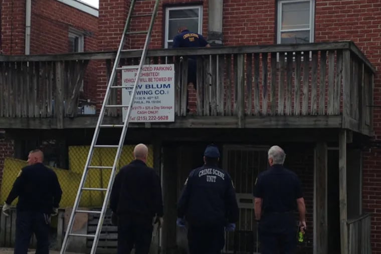 Police investigate at the apartment in Northeast Philadelphia where an intruder killed a 74-year-old woman early Monday, May 6, 2013. (Emily Babay/ Staff)