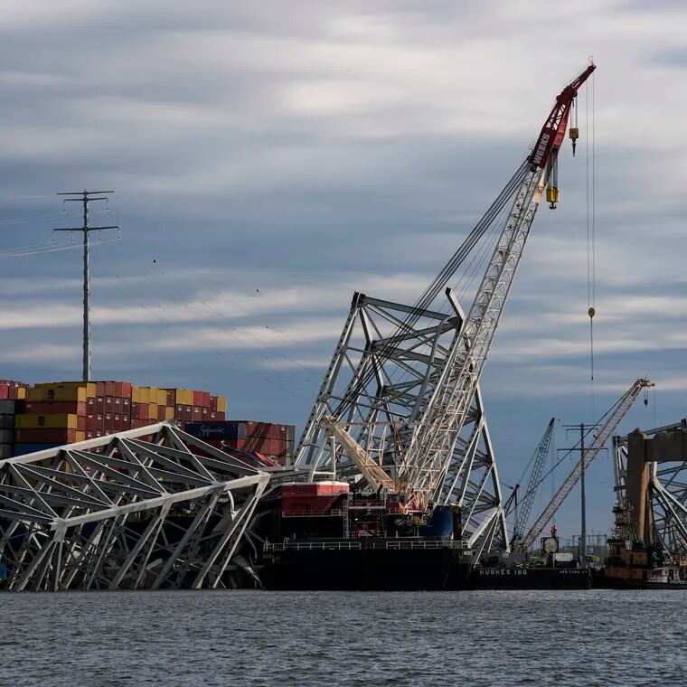 The collapsed Francis Scott Key Bridge lies on top of the container ship Dali, Thursday, April 25, 2024, in Baltimore.