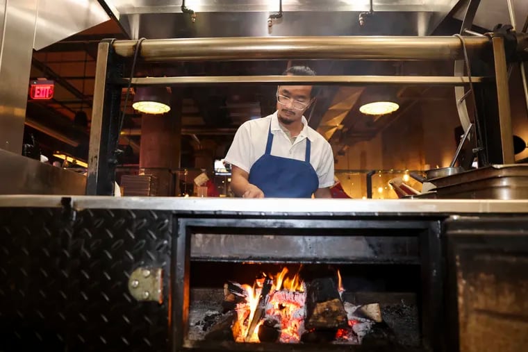 Chef Jacob Trinh works at the grill at the Lucky Well Incubator in Philadelphia, Pa. on Thursday, Dec. 7, 2023.