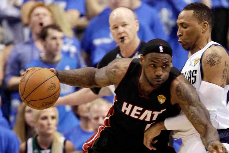 Miami's LeBron James tries to drive past Dallas' Shawn Marion. Game 5 of the NBA Finals ended too late for this edition.