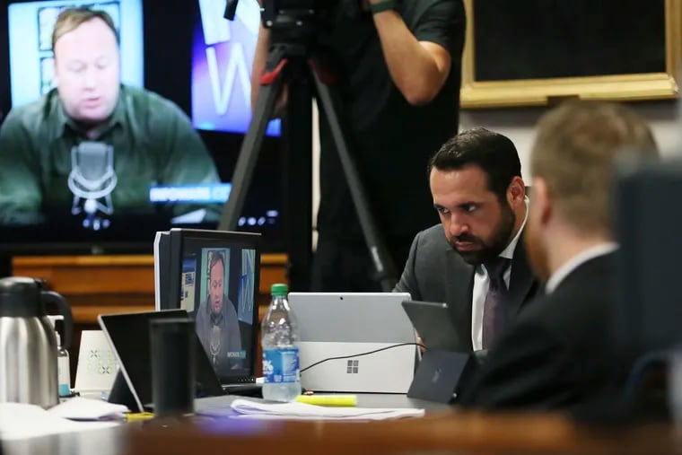 Bill Ogden, partner with the firm representing Neil Heslin and Scarlett Lewis, reacts while watching a clip from InfoWars during the trial for Alex Jones on July 28.