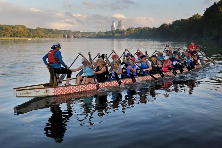 The Senior (over 50) B Dragon Boat crew of the Philadelphia Flying Phoenix club takes off for practice on the Schuylkill, with Colleen Law (left, forward) on the bow as the drummer and Cris Nast (right, rear) on the stern as the steer.