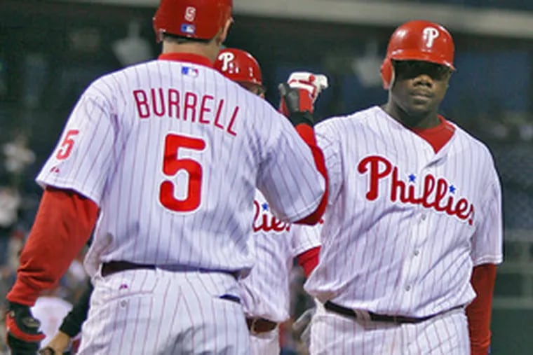 Phillies&#0039; Ryan Howard is greeted by Pat Burrell after his two-run homer.
