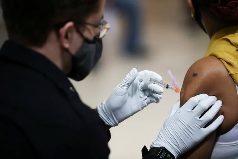 A person is administered a dose of the Johnson & Johnson COVID-19 vaccine at the city’s eighth standing mass vaccination clinic at the Salvation Army at 55th and Market in West Philadelphia on Friday, March 26, 2021.