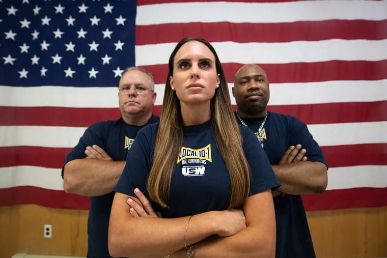 Refinery workers, Shaina Marsden, center, Mike Gioquindo, left, and Terrence Ford, pose for a photograph at the United Steelworkers Local 10-1 in Norwood, Pa. Tuesday, July 2, 2019. Refinery workers talked about the accident at Philadelphia Energy Solutions, and the abrupt closure of the plant last week. .