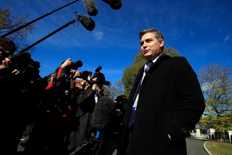 CNN's Jim Acosta speaks to journalists on the North Lawn upon returning back to the White House on Friday.
