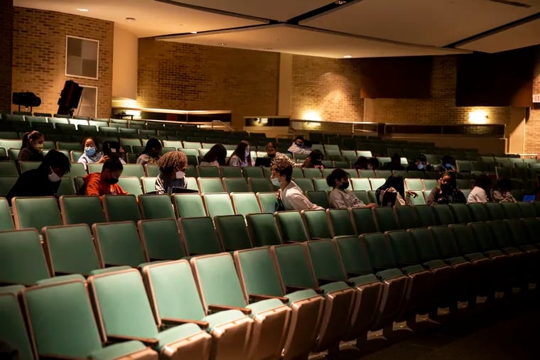 Students in the auditorium at Lakeside Middle School in Millville, N.J., do work left by their teachers who were absent due to COVID-19 on Friday.