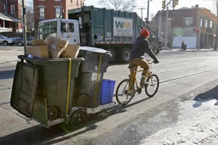 John Paul MacDuffie Woodburn, founder of Pedal Co-Op, transports a load of recyclables after a pickup at the Green Line Cafe on Lancaster Avenue. The firm, with eight riders (or so), also moves compost waste and furniture. (Michael S. Wirtz / Staff Photographer)