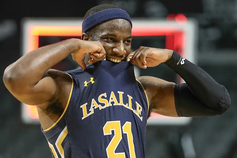 La Salle guard Jordan Price bites his jersey after being defeated by
Davidson.