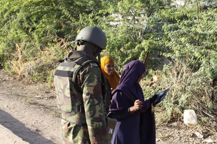 A Kenya Defence Forces soldier secures the area of the Garissa University college, in Garissa, Kenya, Thursday, April 2, 2015. Al-Shabab gunmen attacked Garissa University College in northeast Kenya early Thursday, targeting Christians and killing over 100 people and wounding others, according to Kenya's national disaster operations center and the interior minister. (AP Photo/Khalil Senosi)