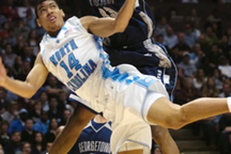 North Carolina&#0039;s Danny Green is fouled by Georgetown&#0039;s Patrick Ewing Jr. during the East Regional final in East Rutherford, N.J.