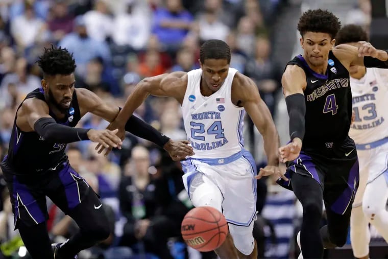 Washington's Jaylen Nowell, left to right, North Carolina's Kenny Williams and Washington's Matisse Thybulle battle for a loose ball in the first half during a second round men's college basketball game in the NCAA Tournament in Columbus, Ohio, Sunday, March 24, 2019. (AP Photo/Tony Dejak)