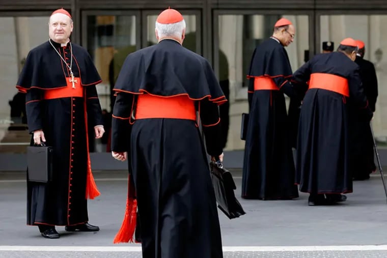 Cardinal Gianfranco Ravasi (left) and other cardinals arriving fora meeting at the Vatican on Friday. ALESSANDRA TARANTINO / Associated Press