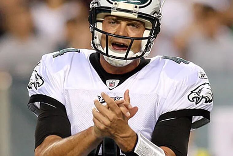 Kevin Kolb is wearing a play card on his wrist, something Donovan McNabb never did. (Steven M. Falk/Staff Photographer)
