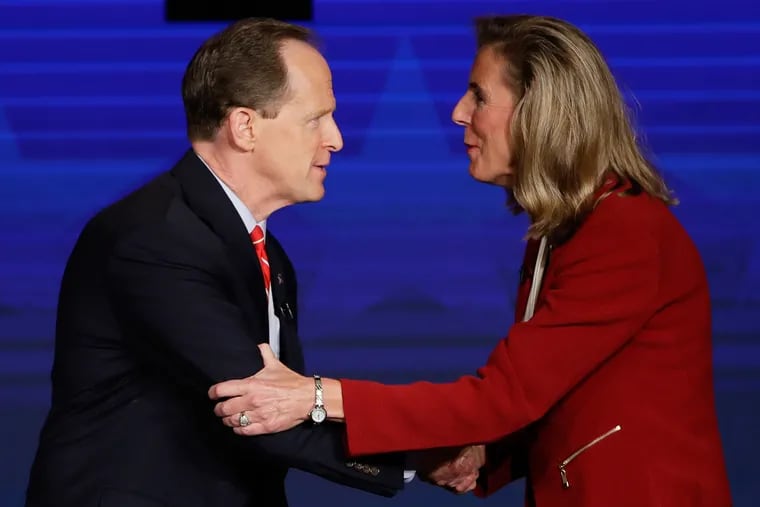 Republican Sen. Pat Toomey and Democrat Katie McGinty shake hands at the end of a debate at Temple University on Oct. 24.