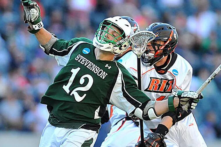 Stevenson College midfielder Peter Green gets checked by Rochester Institute of Technology's defenseman Evan Burley in the NCAA Div. III championship game. (Clem Murray/Staff Photographer)