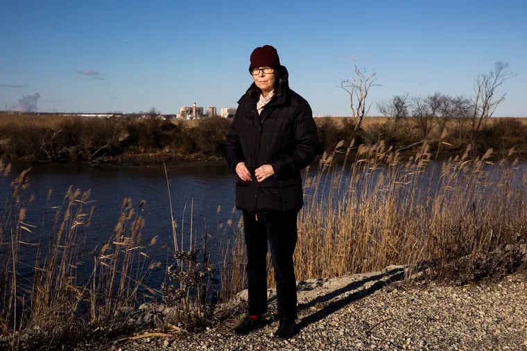 Tracy Carluccio, deputy director of the Delaware Riverkeeper Network, poses for a photo on the banks of the Delaware River in Gibbstown, N.J., on Dec. 29, 2020.